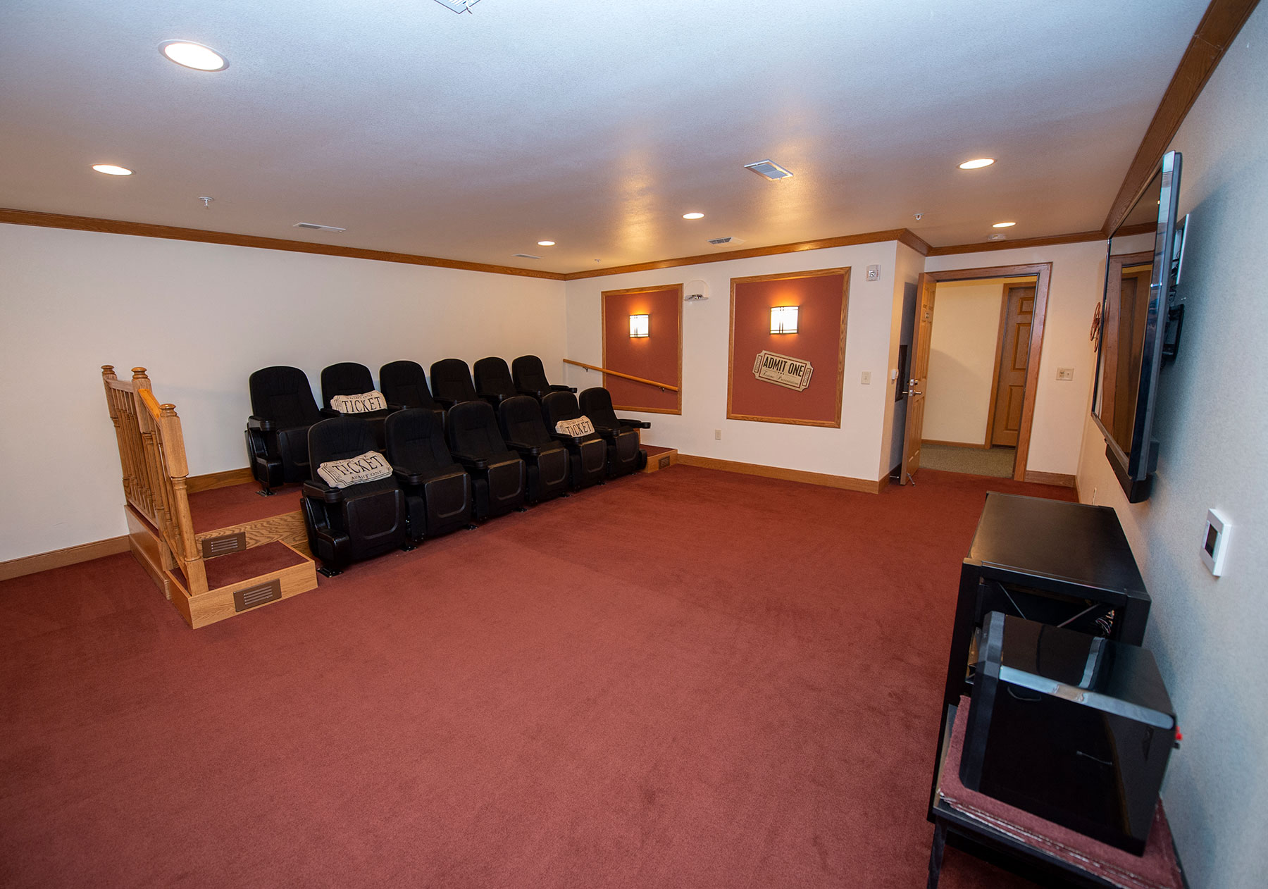 a room with a couch and chairs in it and a tv