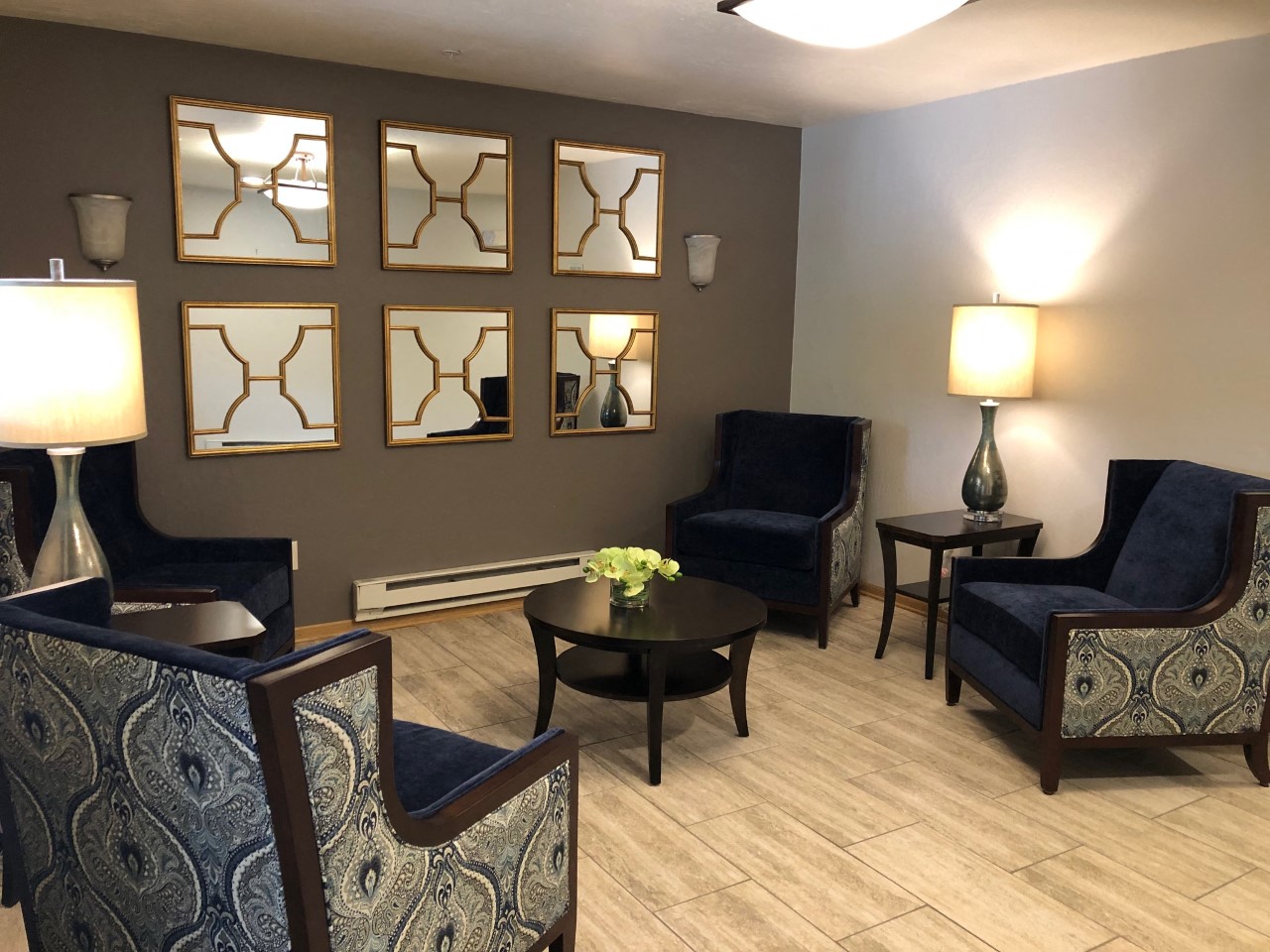 a living room with chairs and a table