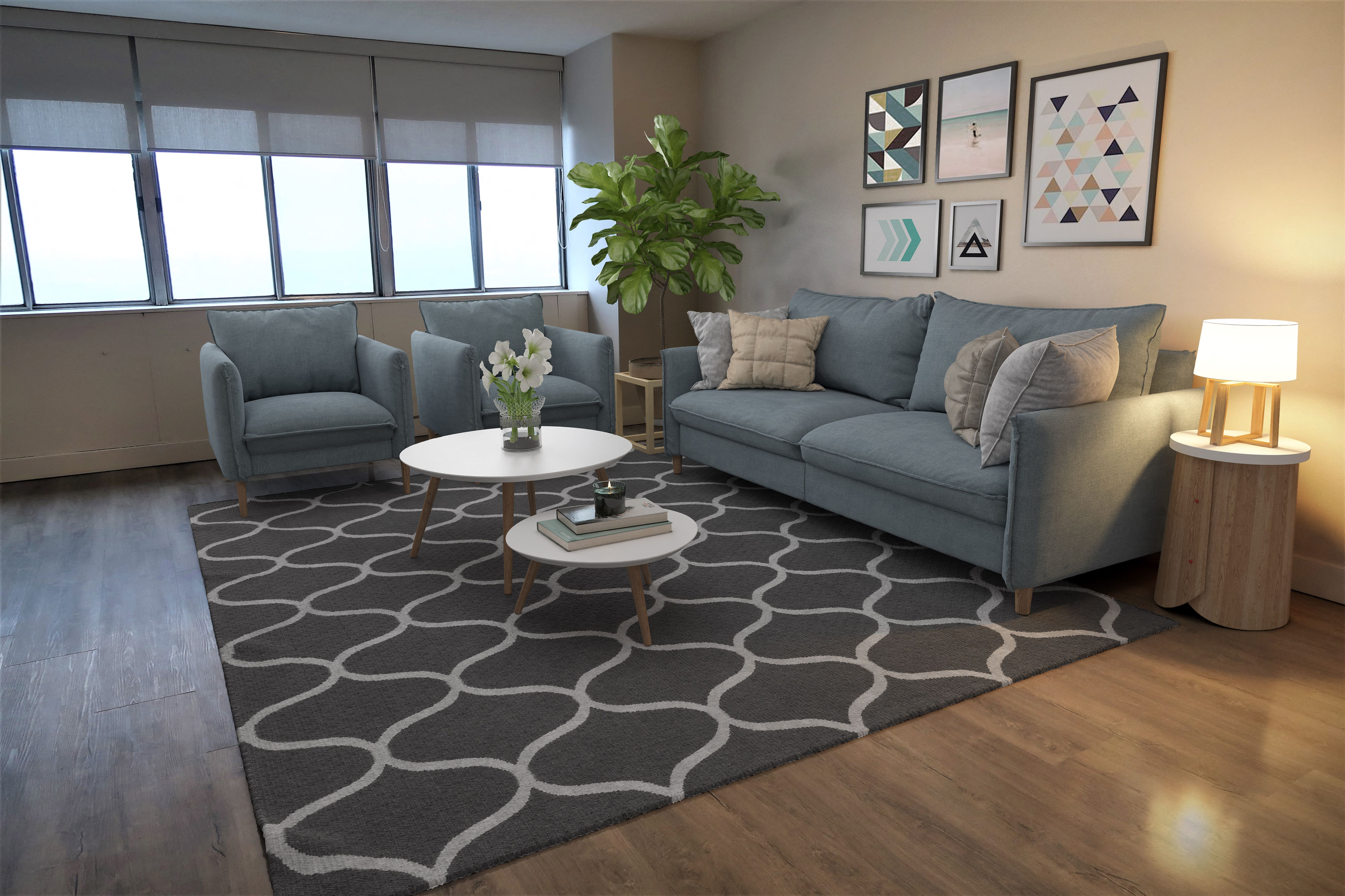 a living room with gray couches and a rug