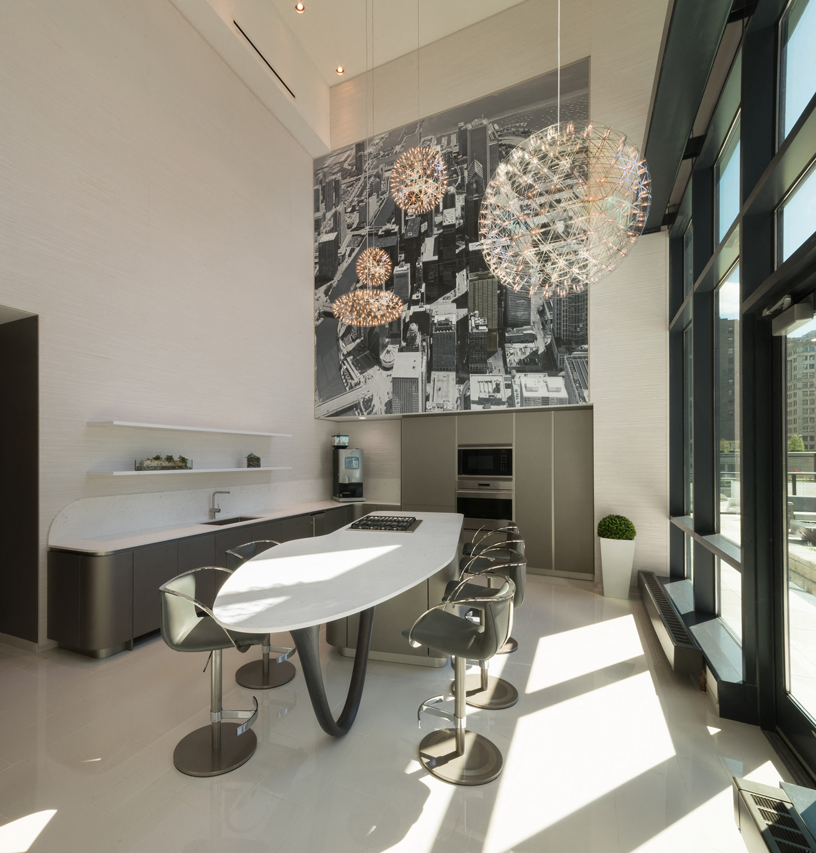 A modern kitchen with a large table and chairs.
