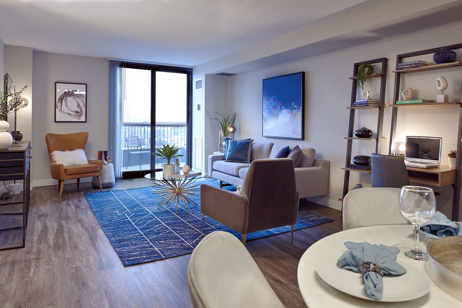 A modern living room with a dining table set for two.