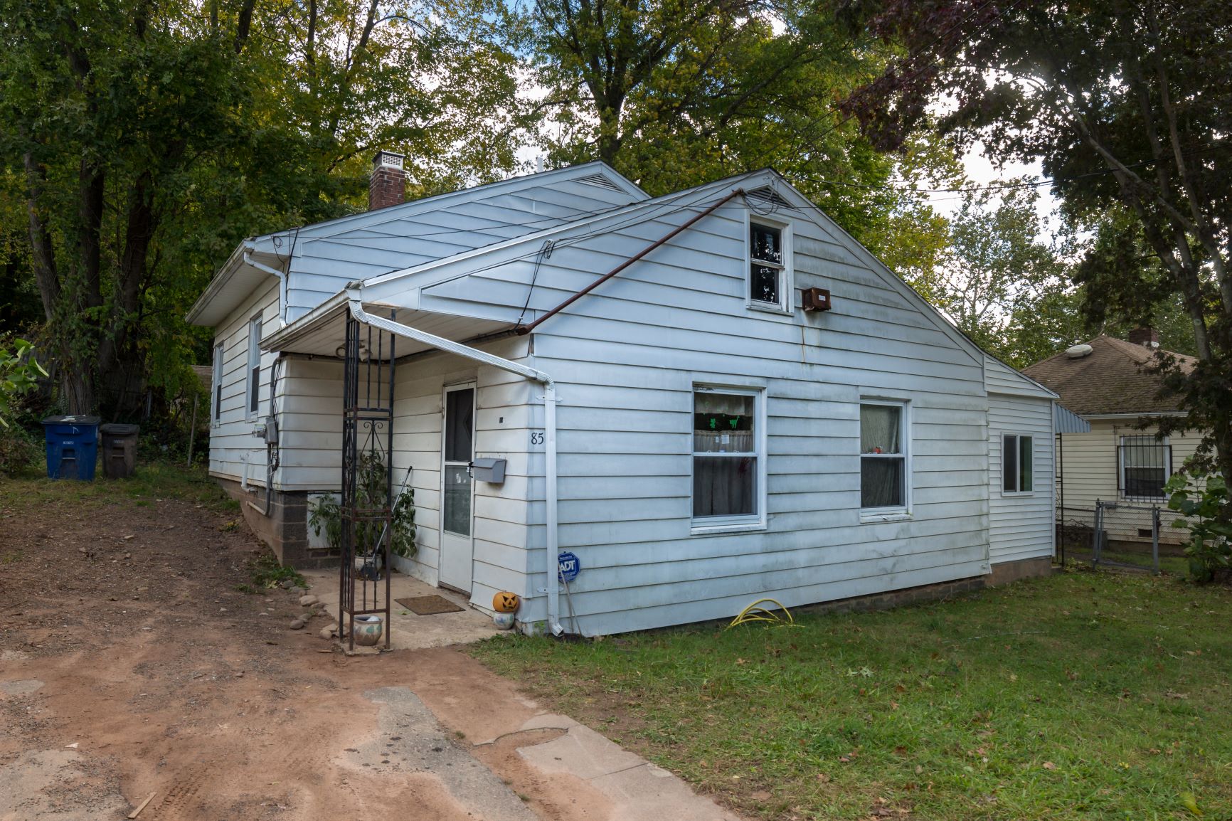 A blue house with a white door and windows.