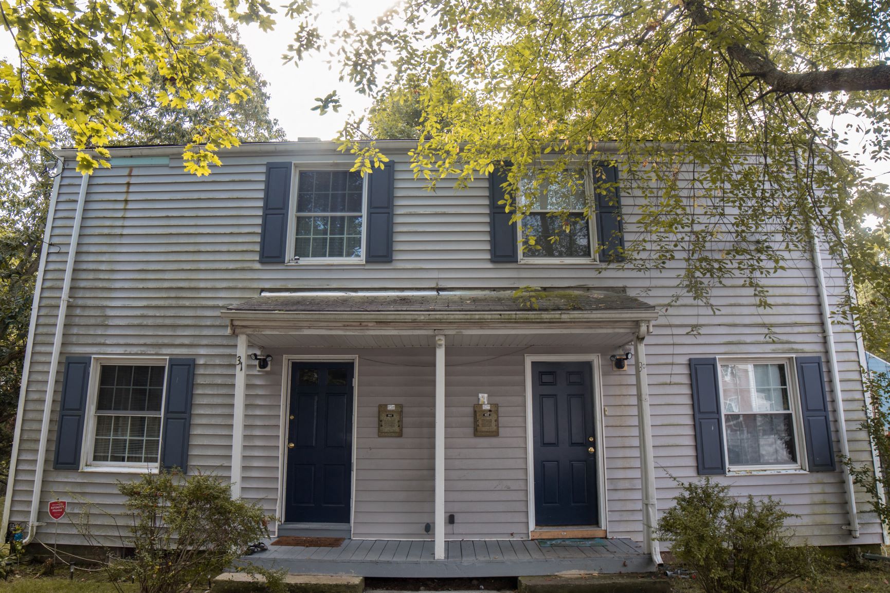 A house with a blue door and two windows.