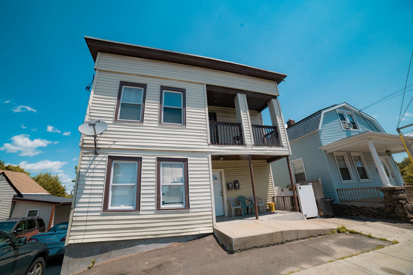 A two-story house with a balcony on the second floor.