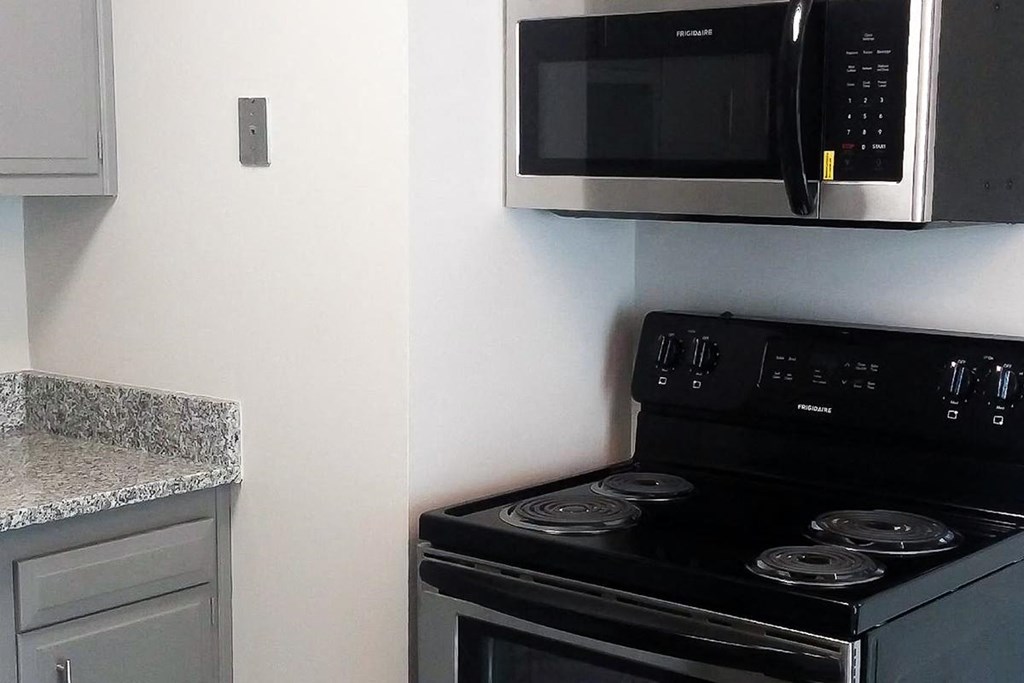 a kitchen with a stove and a microwave