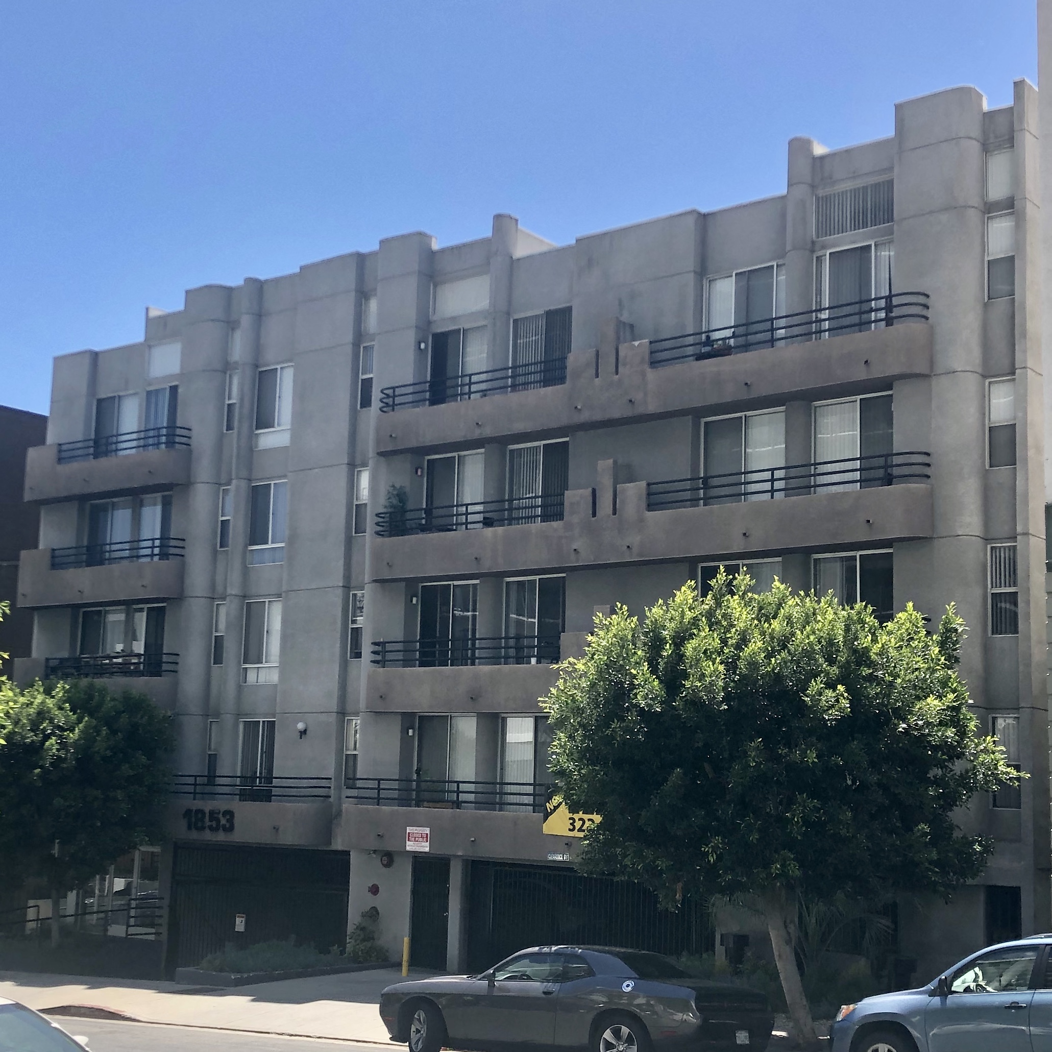 an apartment building on the corner of a city street
