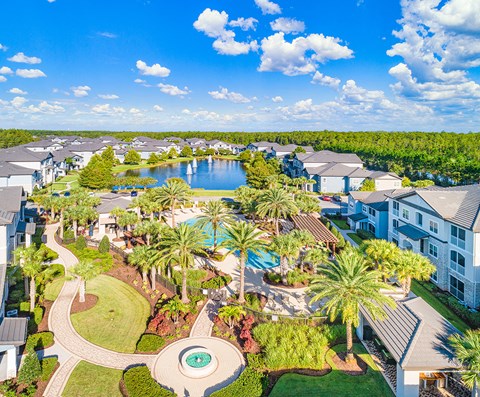 an aerial view of the resort with a pool and a lake