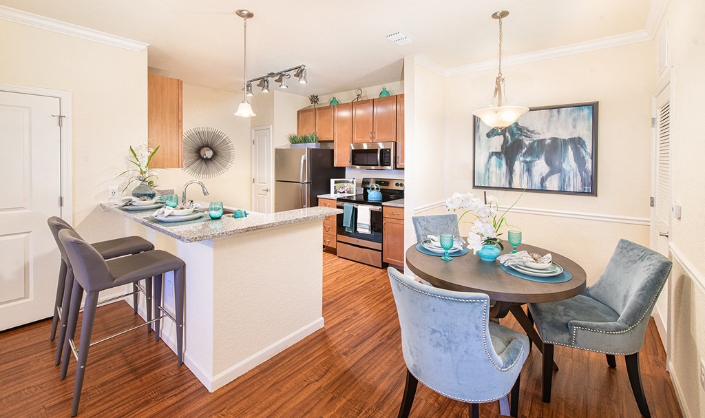 a kitchen and dining area with a table and chairs