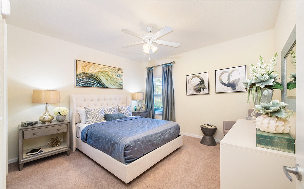 a bedroom with a bed and a ceiling fan
