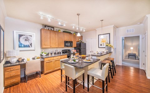 a kitchen with a large island and a table with chairs