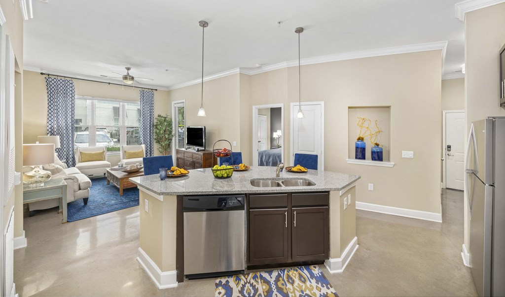 a kitchen with an island and a living room with a couch