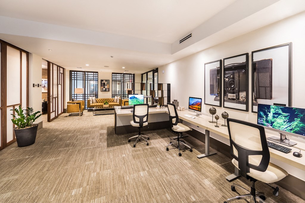 a large office with two desks and two computer monitors