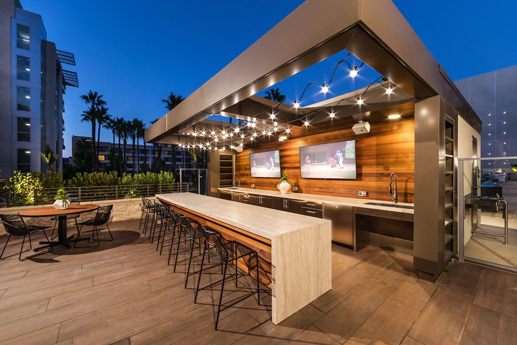 a patio with a bar and a tv
