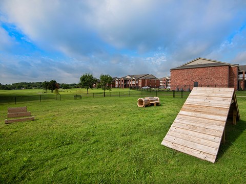 a dock on the grass in front of a building