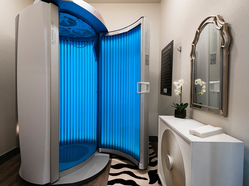 a bathroom with a shower and a sink and a blue tub