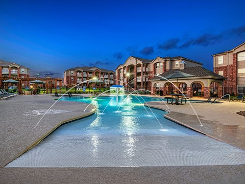 the preserve at ballantyne commons pool with water fountain at night