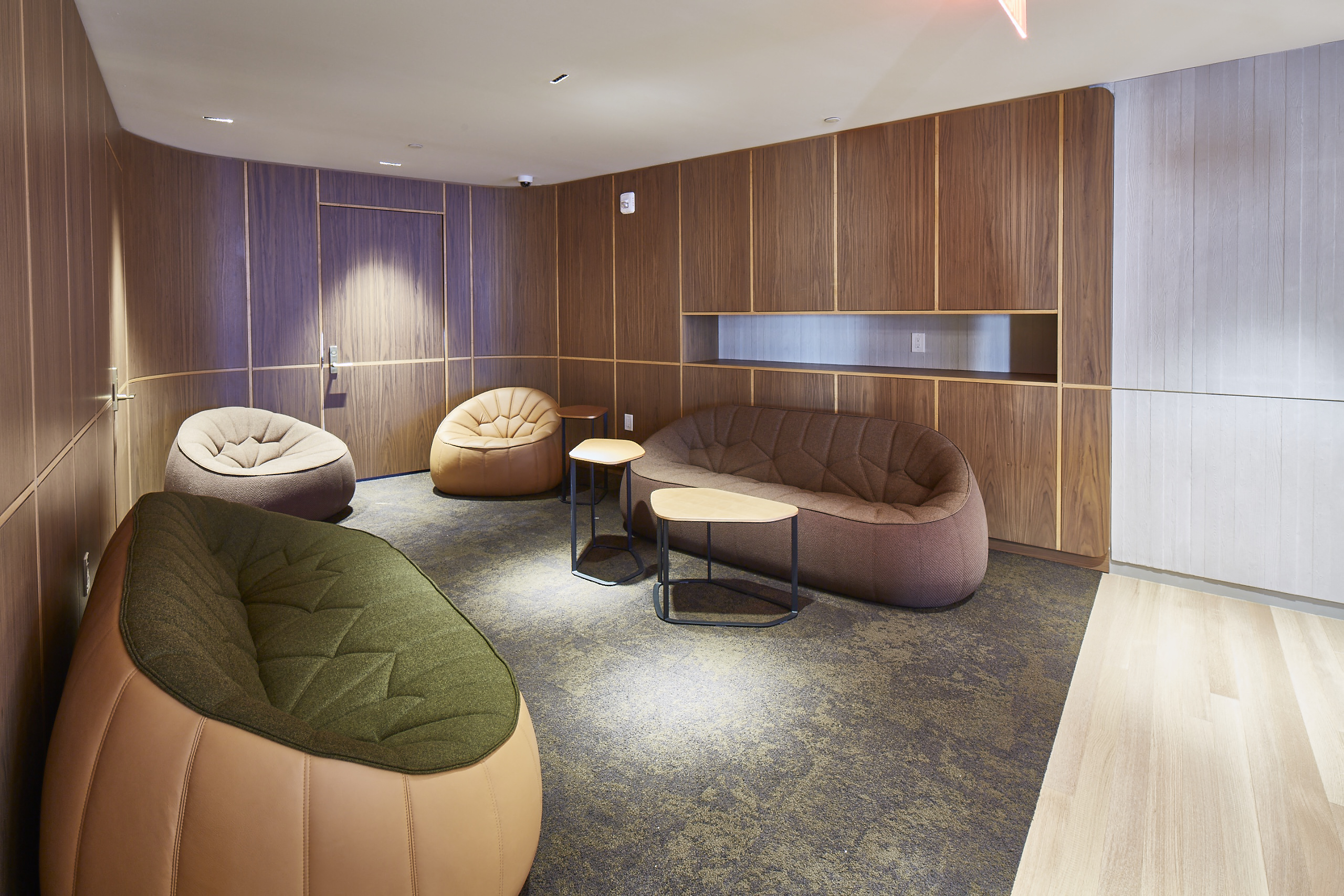 a lounge area with couches and chairs and a table