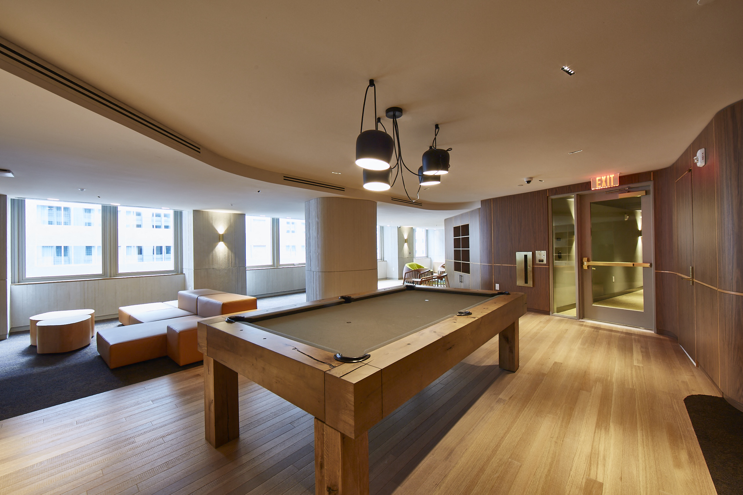a large room with a pool table and couches