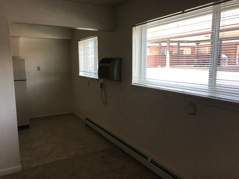 A room with a window and a wall-mounted air conditioner unit.