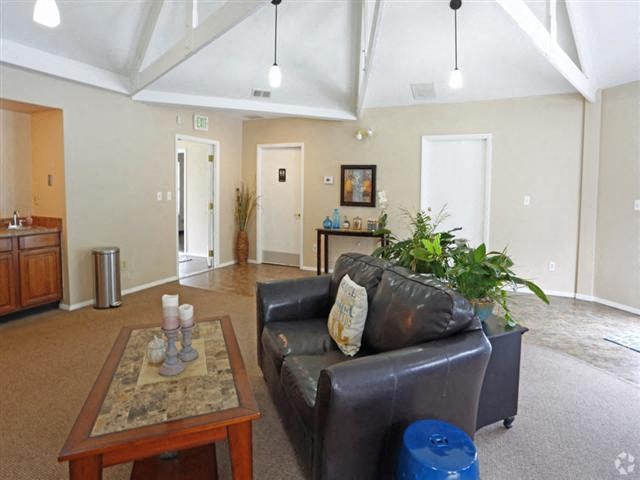a living room with a leather couch and a coffee table