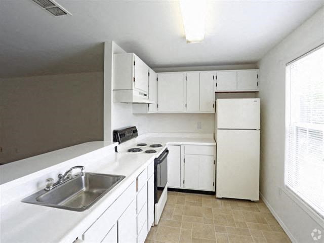 a kitchen with white cabinets and a sink