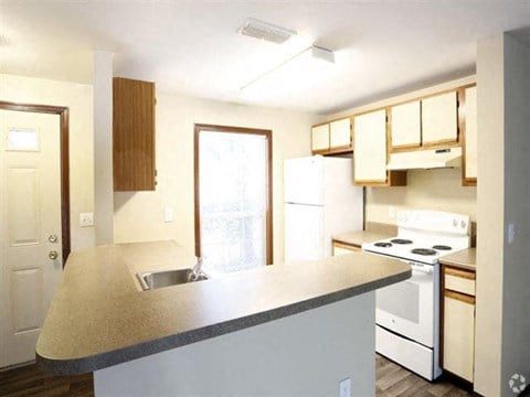 a kitchen with white appliances and a counter top