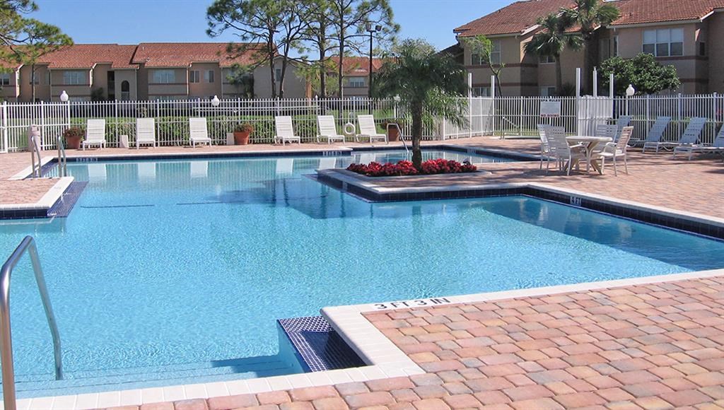 a large swimming pool with chairs around it