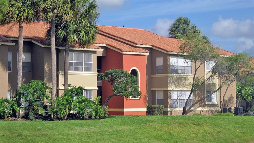 a house with palm trees in front of it