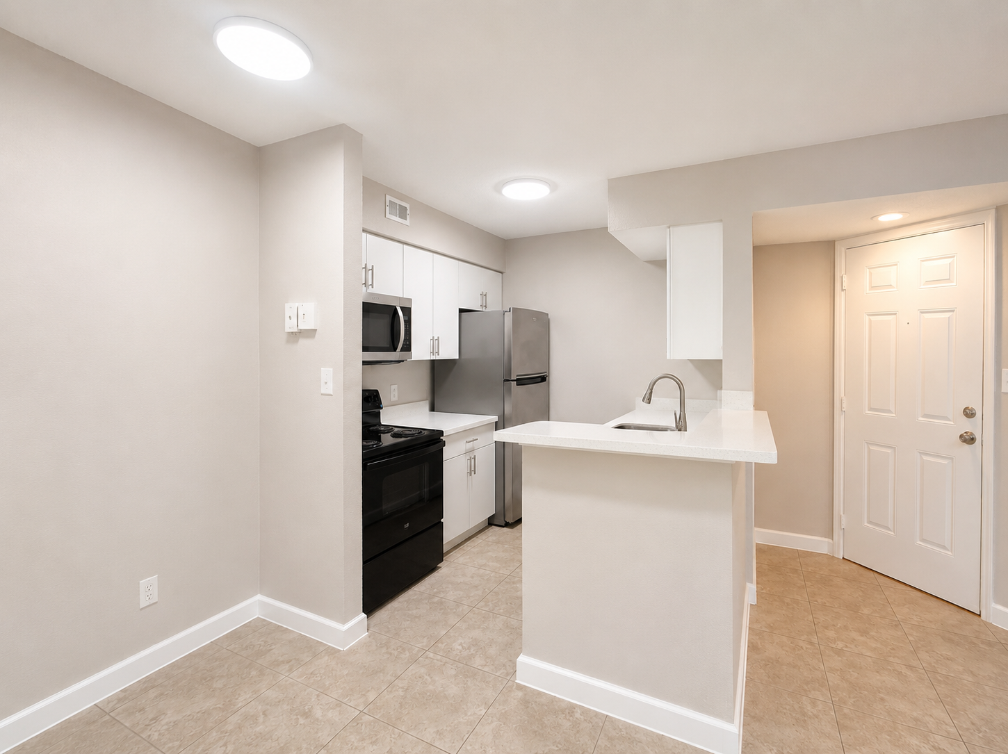 A kitchen with white cabinets and appliances.