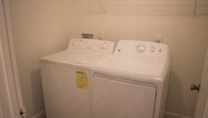 a white washer and dryer in a white room