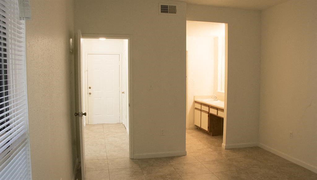 an empty bathroom with a sink and a door
