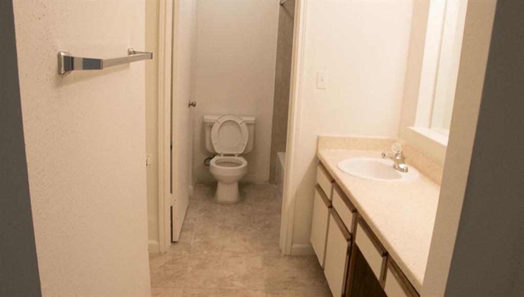an empty bathroom with a toilet and a sink