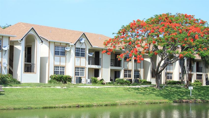a large apartment building next to a body of water