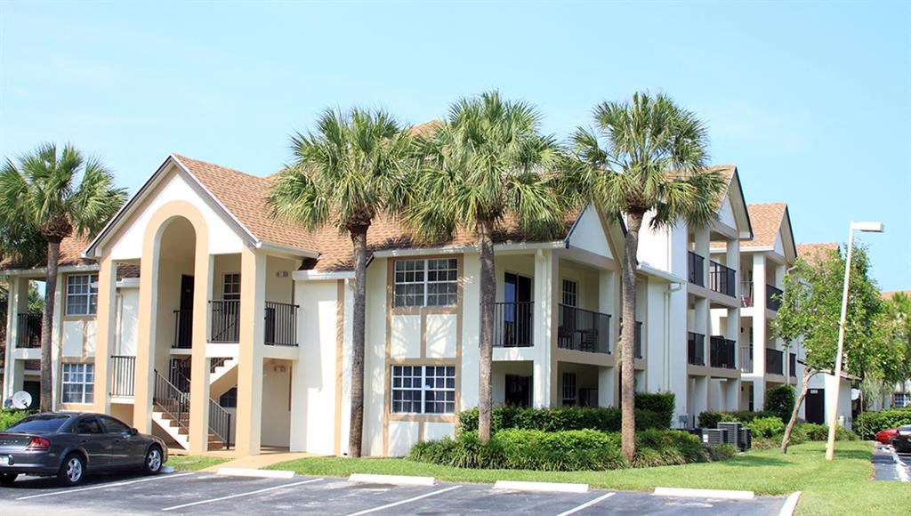 a building with palm trees in front of it