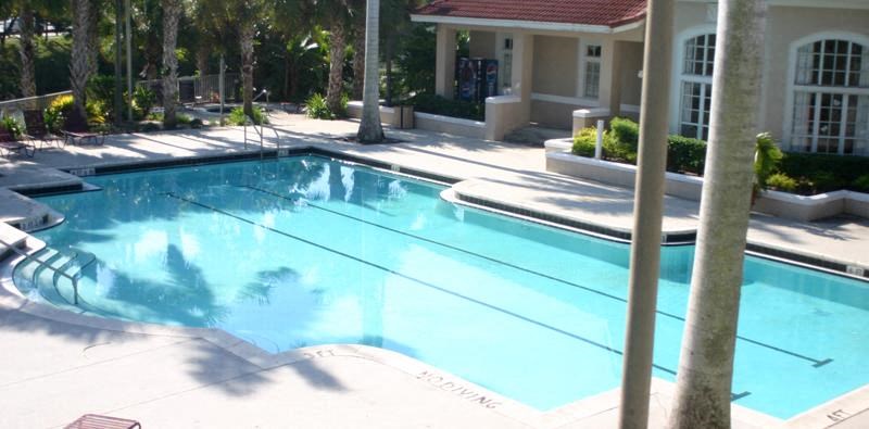 a large swimming pool in front of a house
