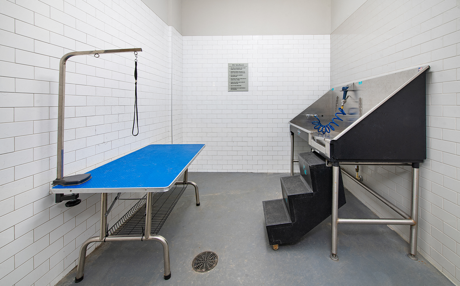 a fitness room with a pool table and a treadmill