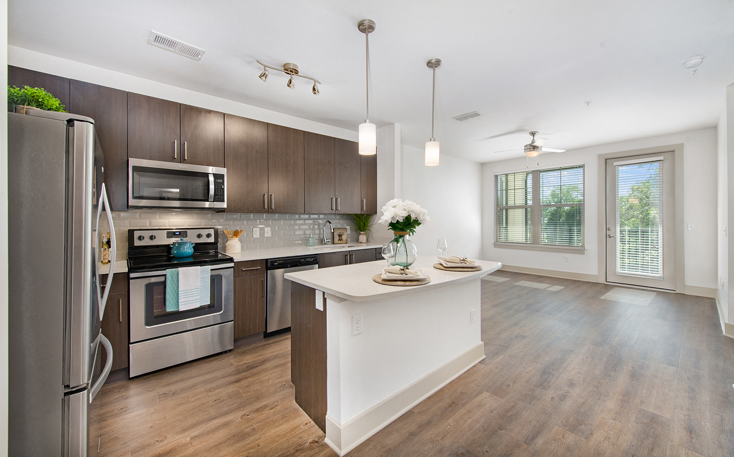 a kitchen with stainless steel appliances and a white counter top