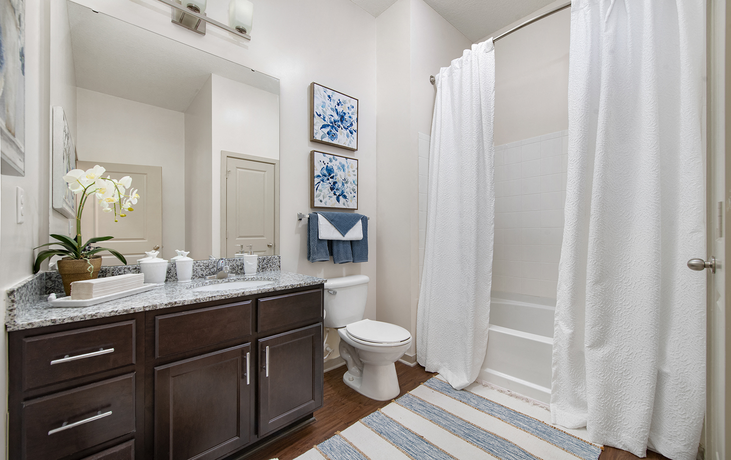 a bathroom with a shower and a toilet and a sink