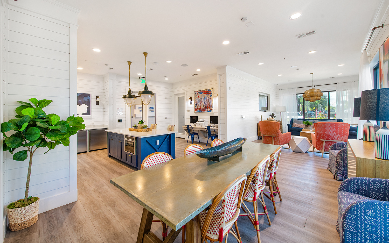 a living room and dining room with a wooden table and chairs