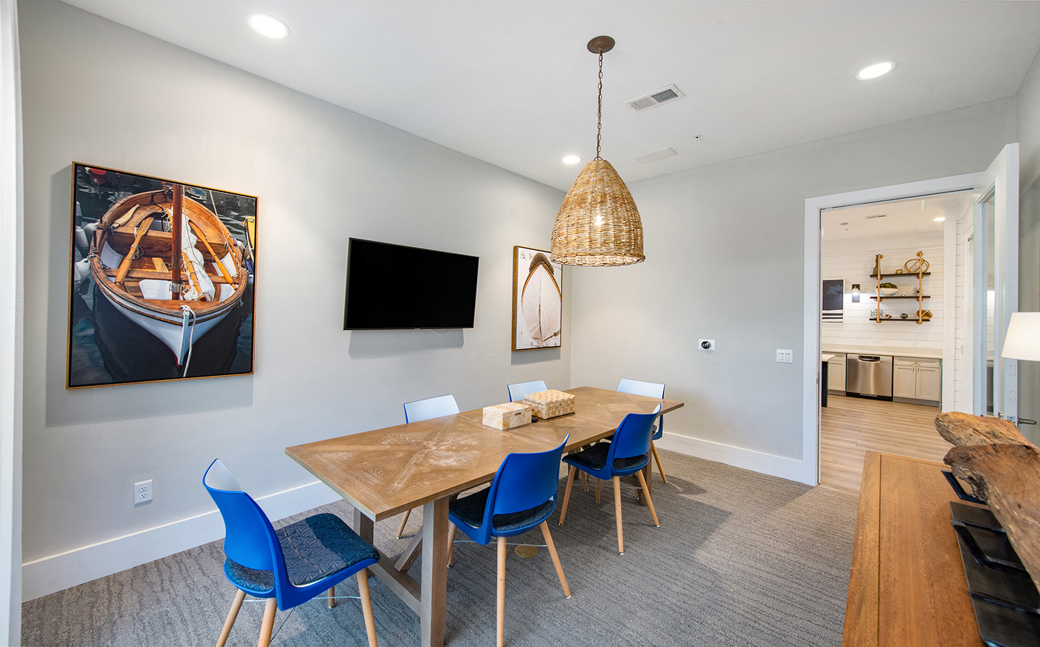 a dining room with a wooden table and blue chairs