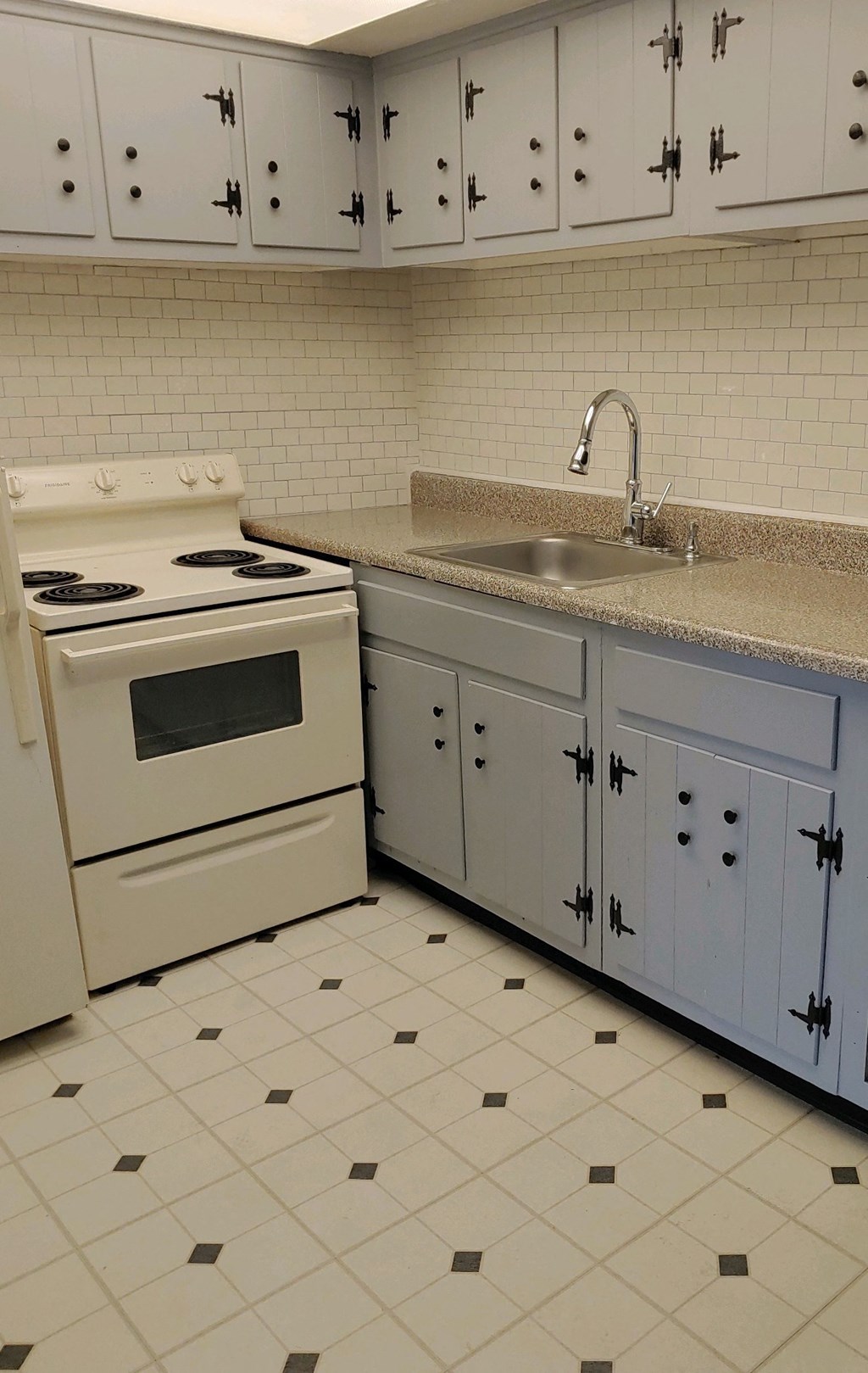 a kitchen with a sink and a stove