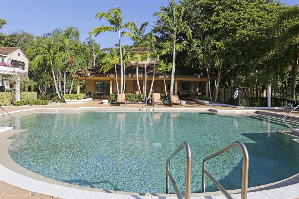 a swimming pool at a resort with palm trees