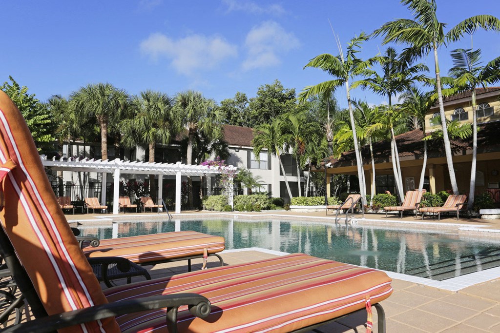 a swimming pool at a resort with palm trees