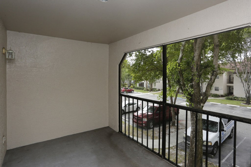the view from the balcony of an apartment with a large window