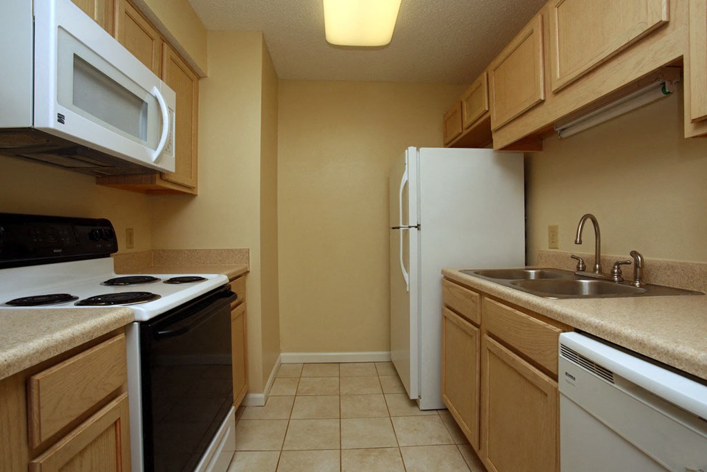 a kitchen with a stove refrigerator and sink