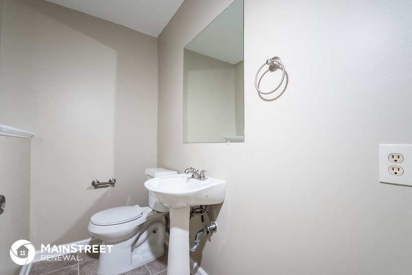 a small bathroom with a sink and toilet and a mirror