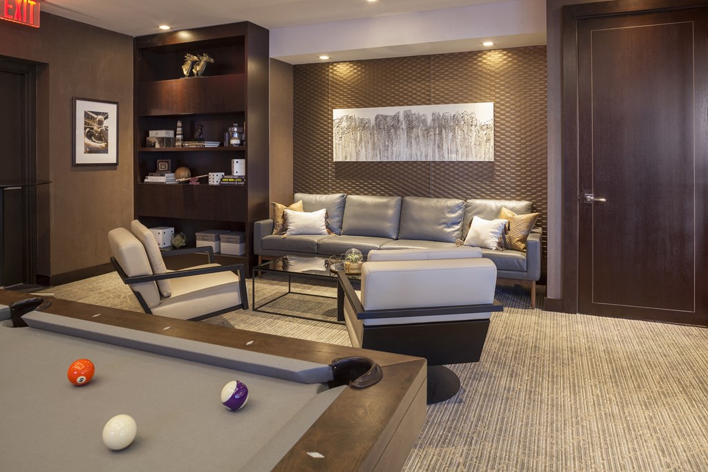 a living room with a pool table and a couch