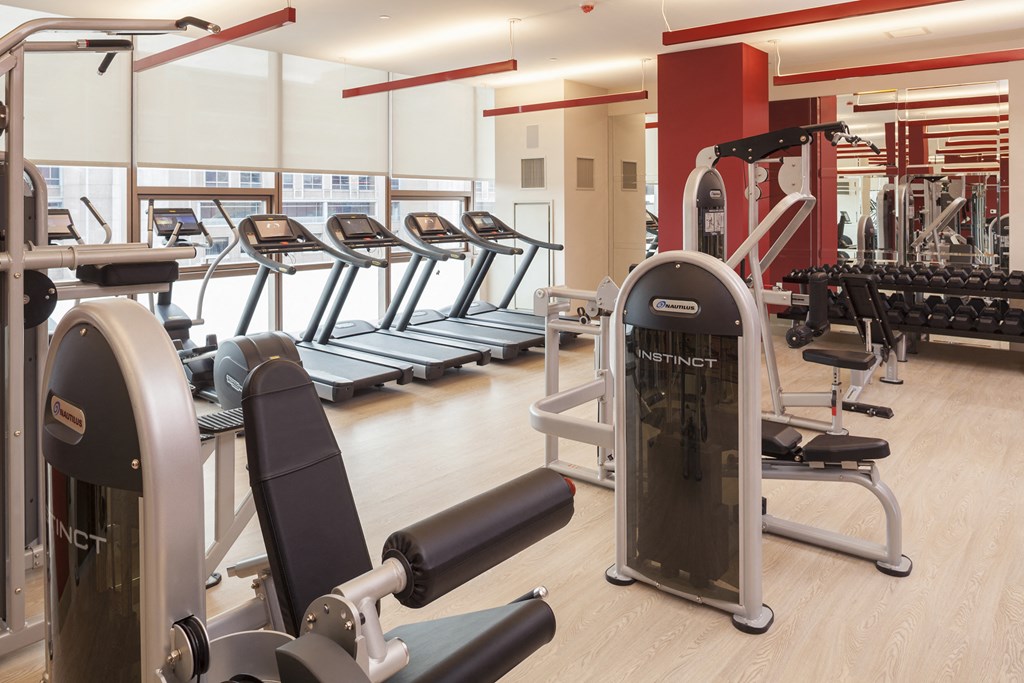 a gym with cardio machines and other exercise equipment