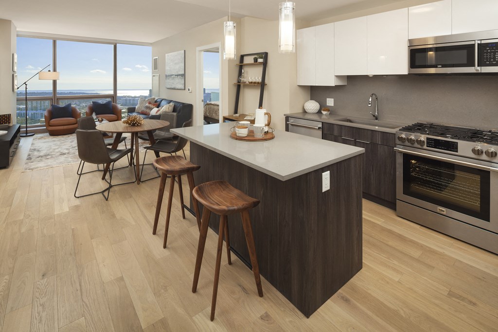 a kitchen and living room with an island and stools