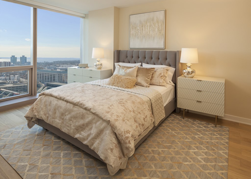 a bedroom with a bed and a large window